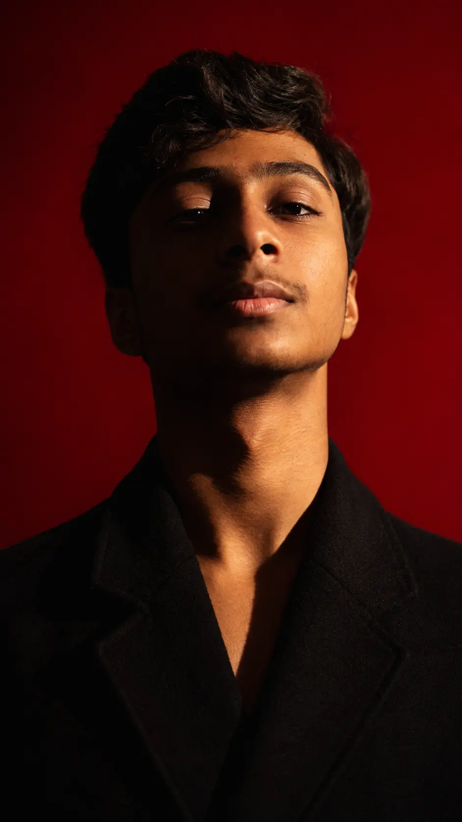 Ali Hassan crimson studio portrait — AliHx Portfolio visual